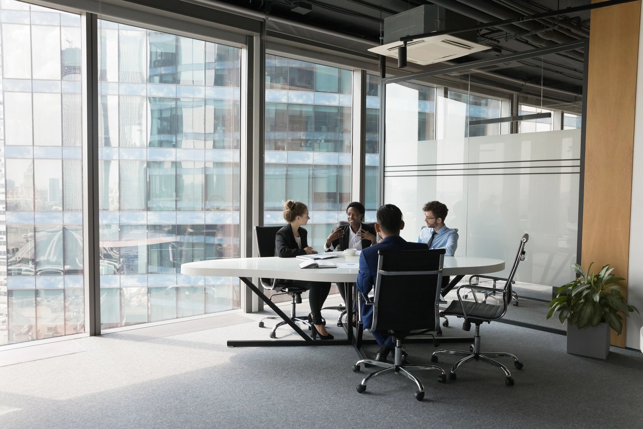 IT consulting team discussing strategy in a modern office
