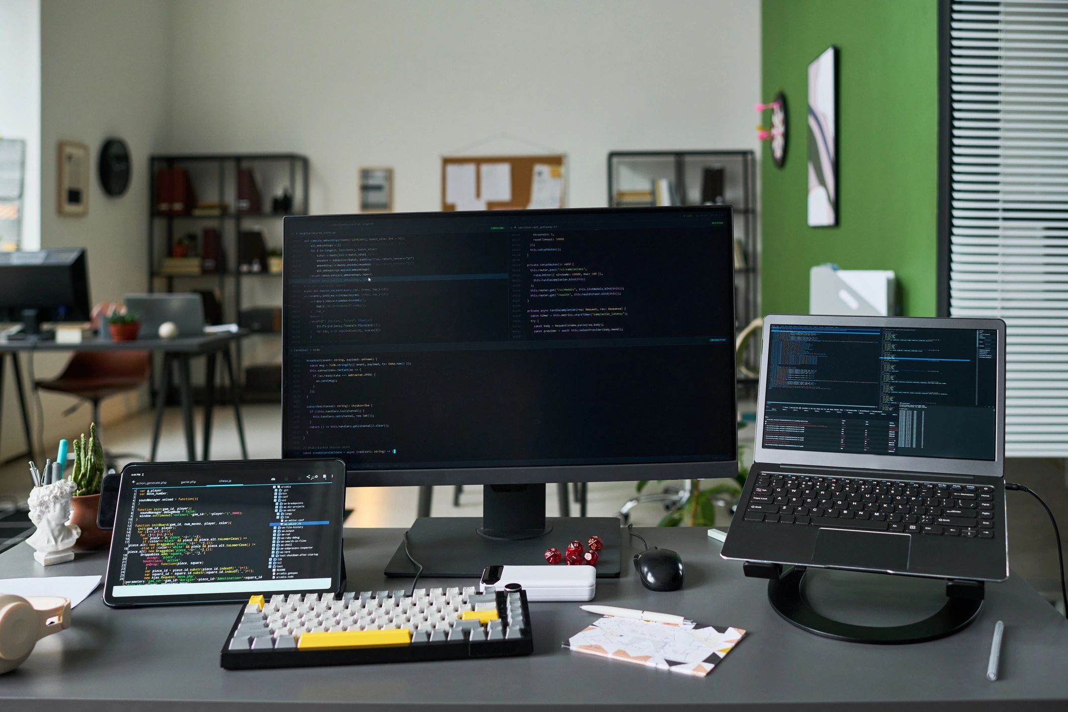 Software development workspace with multiple screens displaying code