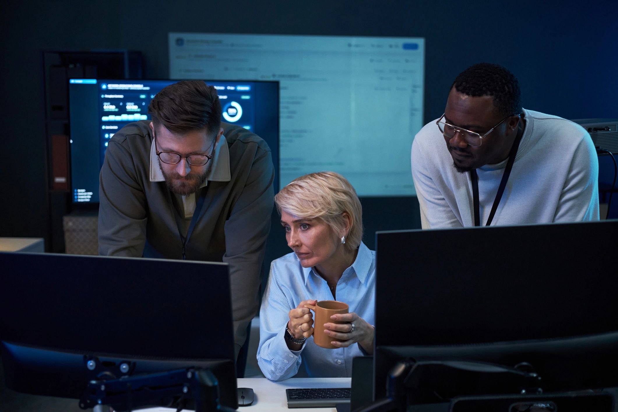 IT professionals collaborating in a cybersecurity operations workspace